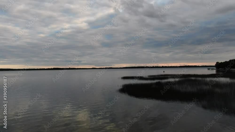 Drone flying over calm lake at dusk, 4k footage Drone flying over calm lake at dusk, 4k footage