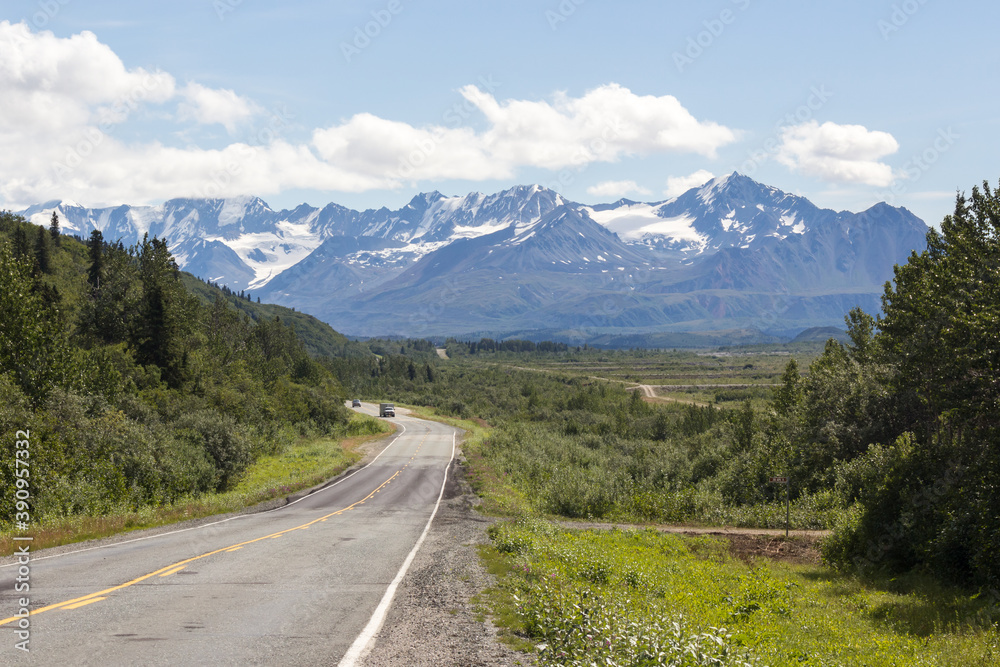 Alaskan Highway in summer. Beautiful mountain range on the background Alaskan Highway in summer. Beautiful mountain range on the background