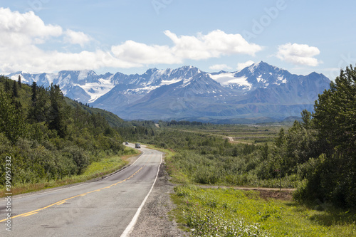Alaskan Highway in summer. Beautiful mountain range on the background