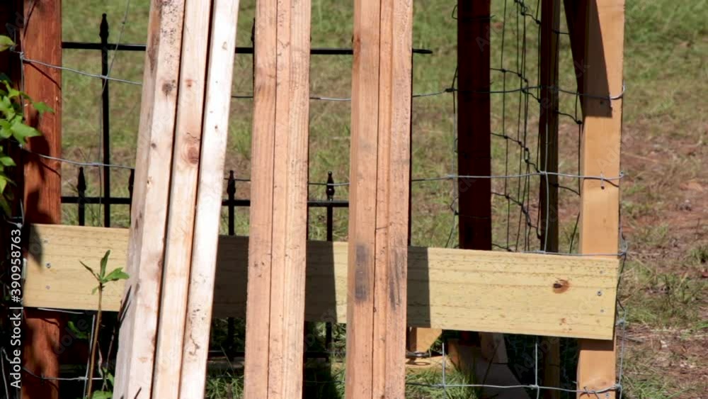 A simple shot of a wood project under construction. It was for a large animal transport cage. In the shot there are wooden fence boards stacked atop of the structure and some wood stacked upright. A simple shot of a wood project under construction. It was for a large animal transport cage. In the shot there are wooden fence boards stacked atop of the structure and some wood stacked upright.