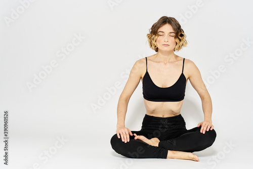 woman in dark clothes sitting on the floor and meditation exercises for legs leggings