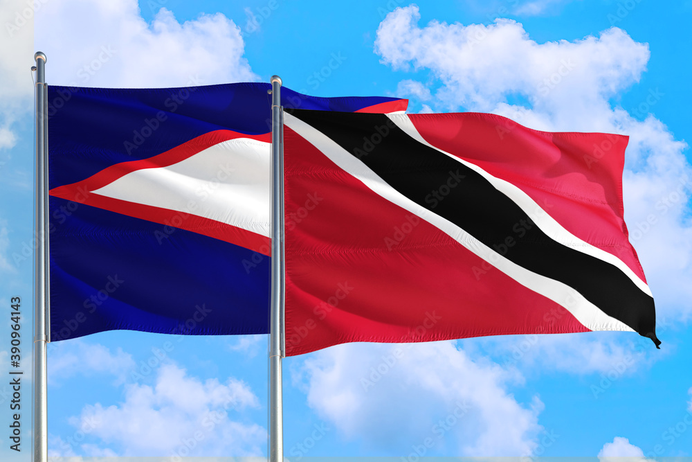 Trinidad And Tobago and American Samoa national flag waving in the windy deep blue sky. Diplomacy and international relations concept. Trinidad And Tobago and American Samoa national flag waving in the windy deep blue sky. Diplomacy and international relations concept.