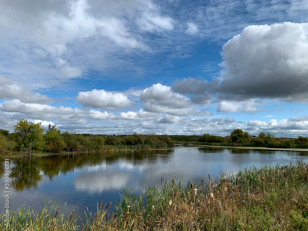 Landscape clouds over lake reflection of sky in water