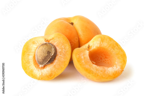 Apricot with two halves isolated on white