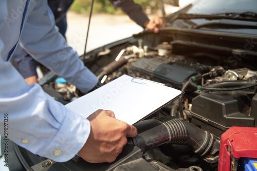 Wallpaper Mural Auto mechanic using checklist for car engine systems after fixed. Concepts of car fix and checking repair and service maintenance. Torontodigital.ca