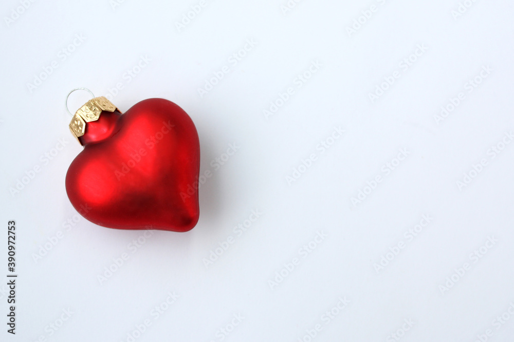 Christmas toy in the form of a heart on a white background. There is room for text. Christmas toy in the form of a heart on a white background. There is room for text.