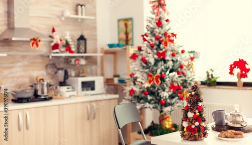 Empty beautiful modern kitchen with delicious cookies for winter holiday. Kitchen on christmas day with nobody in the room decorated with x-mas tree and garlands