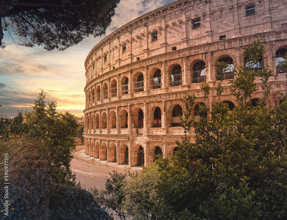 Colosseum ancient arena during sunrise with impressive sky, Rome Italy