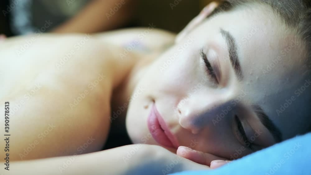 girl getting a massage. close up shoot to her face. 4K. girl getting a massage. close up shoot to her face. 4K.