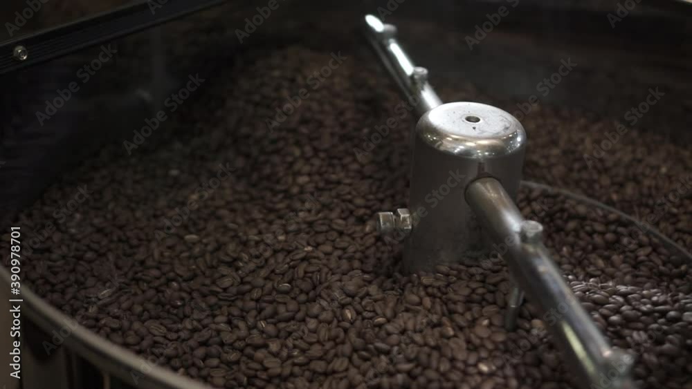 Close up view of coffee beans roasting in machine Close up view of coffee beans roasting in machine