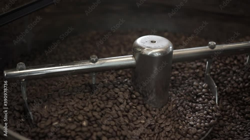 Coffee beans being processed in roasting machine Coffee beans being processed in roasting machine