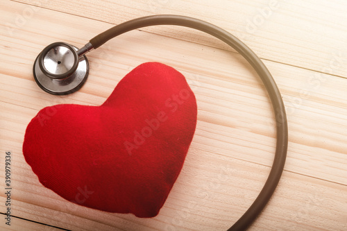 Valentines day background. Red heart on wooden table with copy space