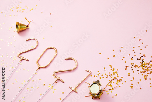 New Year 2021 Golden numbers 2021 with shiny golden stars on a pink background