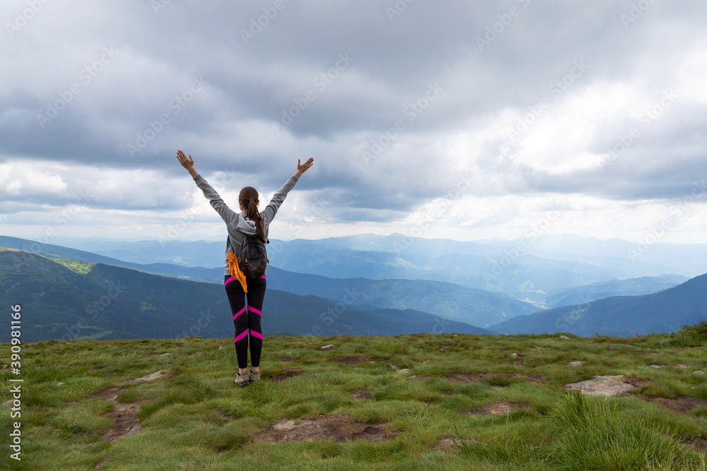 Sporty, happy girl with raised arms on the top of the mountain. Tourism. Sporty, happy girl with raised arms on the top of the mountain. Tourism.