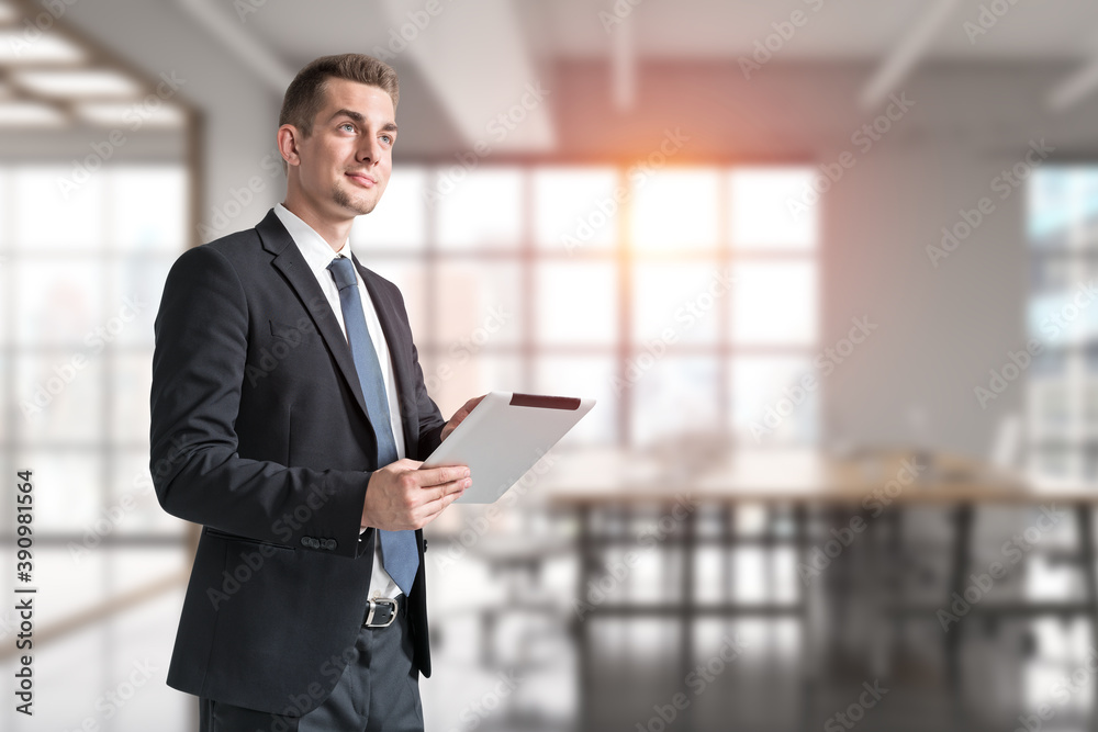Young businessman with tablet in office Young businessman with tablet in office