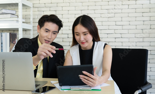 young asian manager discuss about income and profit of corporate with woman in office. business concept