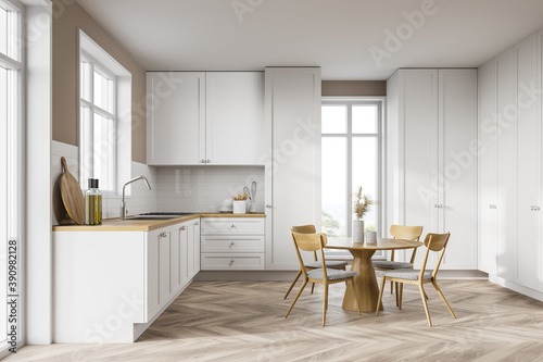 White kitchen interior with cupboards and table