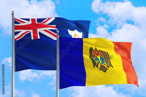 Moldova and Anguilla national flag waving in the windy deep blue sky. Diplomacy and international relations concept.