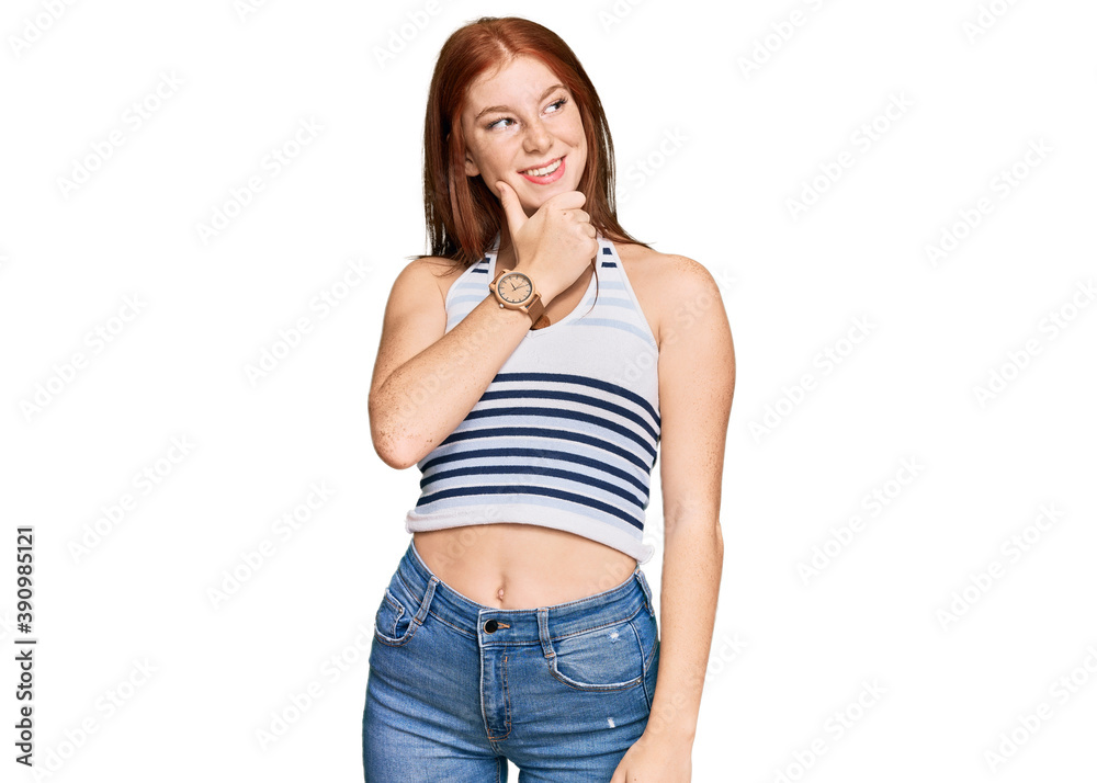 Young read head woman wearing casual clothes with hand on chin thinking about question, pensive expression. smiling with thoughtful face. doubt concept.