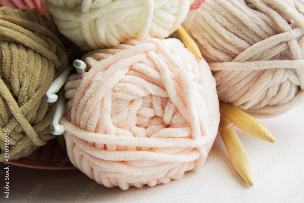 skewers of plush yarn pastel tones with spokes and hooks on a white table skewers of plush yarn pastel tones with spokes and hooks on a white table