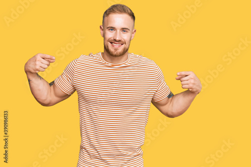 Young irish man wearing casual clothes looking confident with smile on face, pointing oneself with fingers proud and happy.