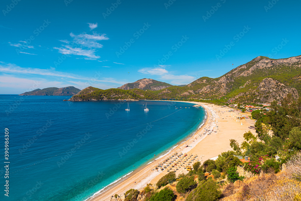 Fototapeta premium Beautiful sandy beach with yachts in Oludeniz, Blue Lagoon in Turkey. Summer holiday travel destination