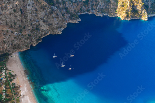 The Butterfly Valley (kelebekler vadisi) with sandy beach and yachts in the city of Oludeniz or Fethiye, Turkey