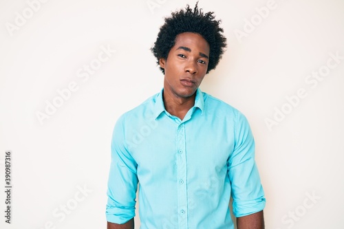 Handsome african american man with afro hair wearing casual clothes skeptic and nervous, frowning upset because of problem. negative person.