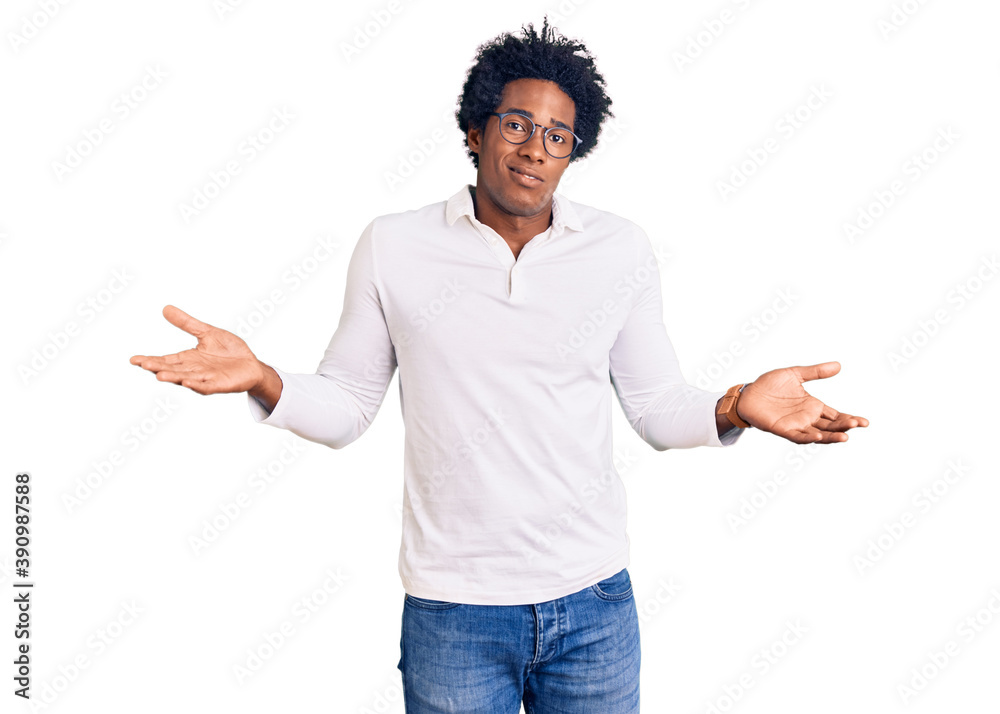 Handsome african american man with afro hair wearing casual clothes and glasses clueless and confused with open arms, no idea concept. Handsome african american man with afro hair wearing casual clothes and glasses clueless and confused with open arms, no idea concept.