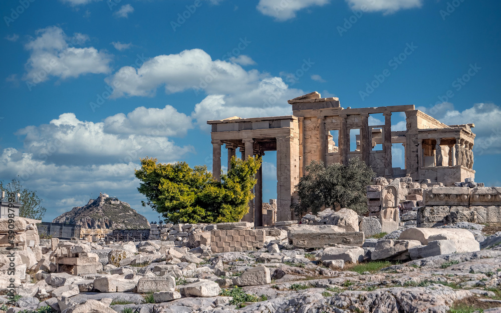 Athens Greece, scenic view of Caryatides statues on Erechtheion ancient temple facade under dramatic sky, filtered image