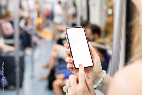 Person using phone while riding in public transport, mockup screen of the phone