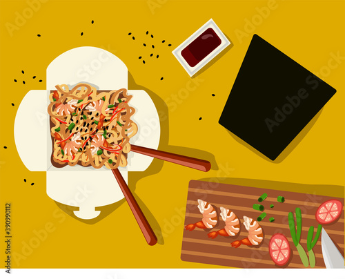 Chinese noodles in a box with shrimps and vegetables with sticks. Wok food delivery from restaurant on dark background from above view.