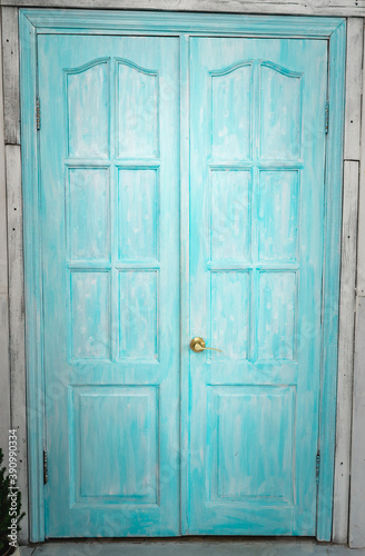 Blue wooden front door to the house.
