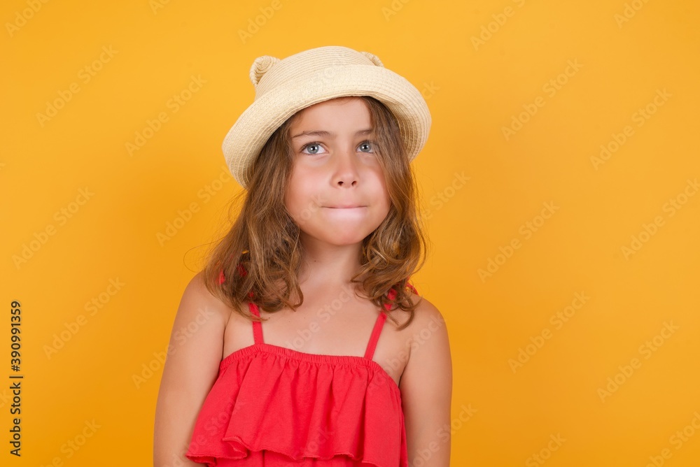 young Caucasian girl standing against yellow background keeps palms together, has pleased expression. Glad attractive male makes request, pleads for mercy. Hopeful young adult. young Caucasian girl standing against yellow background keeps palms together, has pleased expression. Glad attractive male makes request, pleads for mercy. Hopeful young adult.