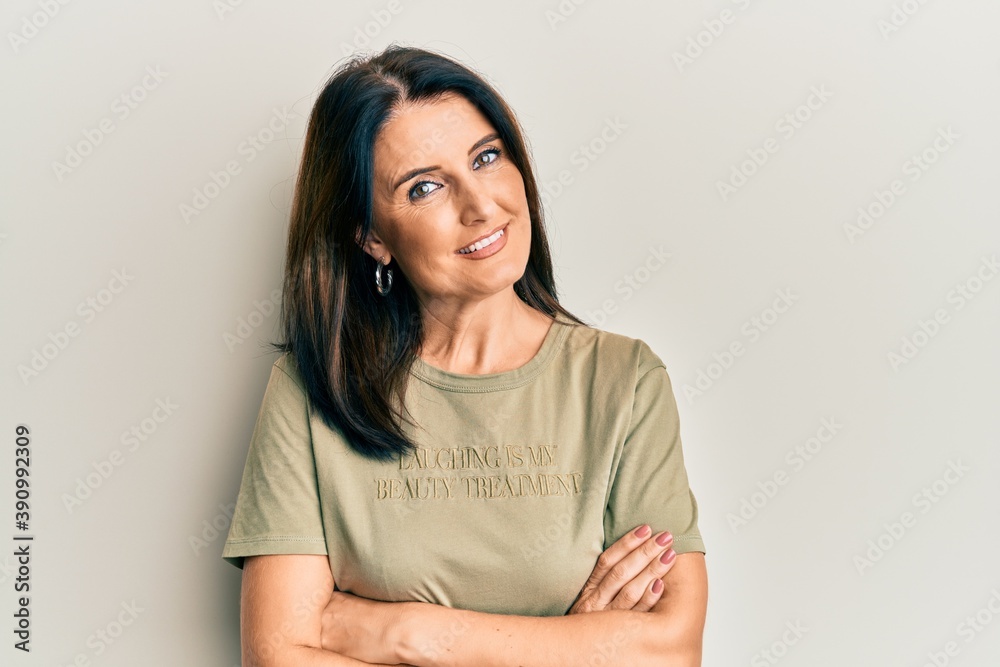 Middle age brunette woman wearing casual clothes happy face smiling with crossed arms looking at the camera. positive person. Middle age brunette woman wearing casual clothes happy face smiling with crossed arms looking at the camera. positive person.