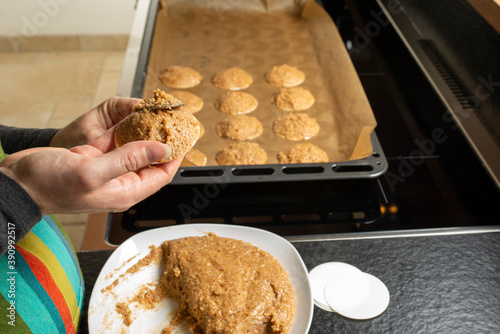 female applying dough on oblate with spoon