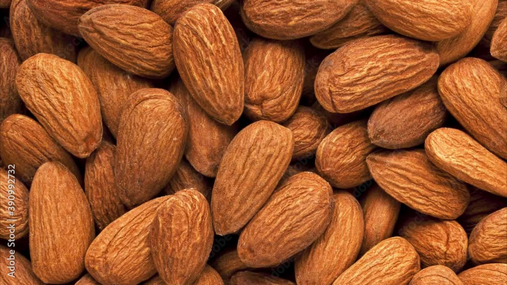 Background and texture of rotating almond nuts. View from above. Background and texture of rotating almond nuts. View from above.
