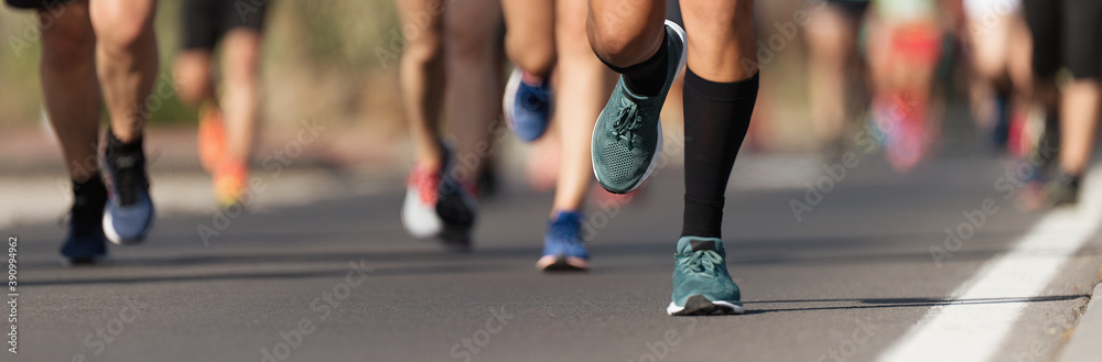 Marathon running race, people feet on city road