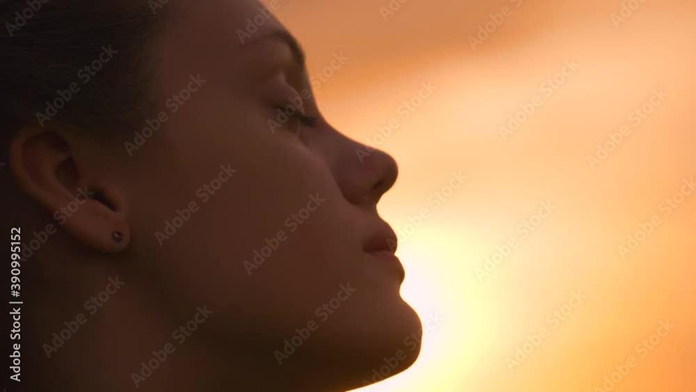 Portrait of a happy young teenager girl on the street. The girl dreams with pleasure with her eyes closed. The lady feels free, successful, ready to start the day, move forward. Portrait of a happy young teenager girl on the street. The girl dreams with pleasure with her eyes closed. The lady feels free, successful, ready to start the day, move forward.