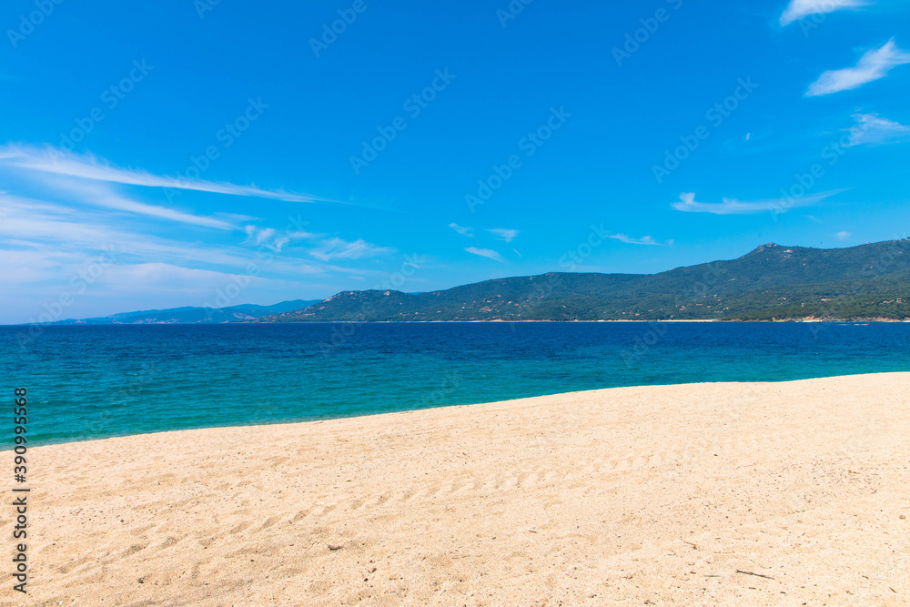 Empty sandy beach with mountain in the background, Beach of Propriano, Corsica, France. Place for Text