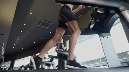 Closeup sprotsman leg walking and jogging run on treadmill at gym