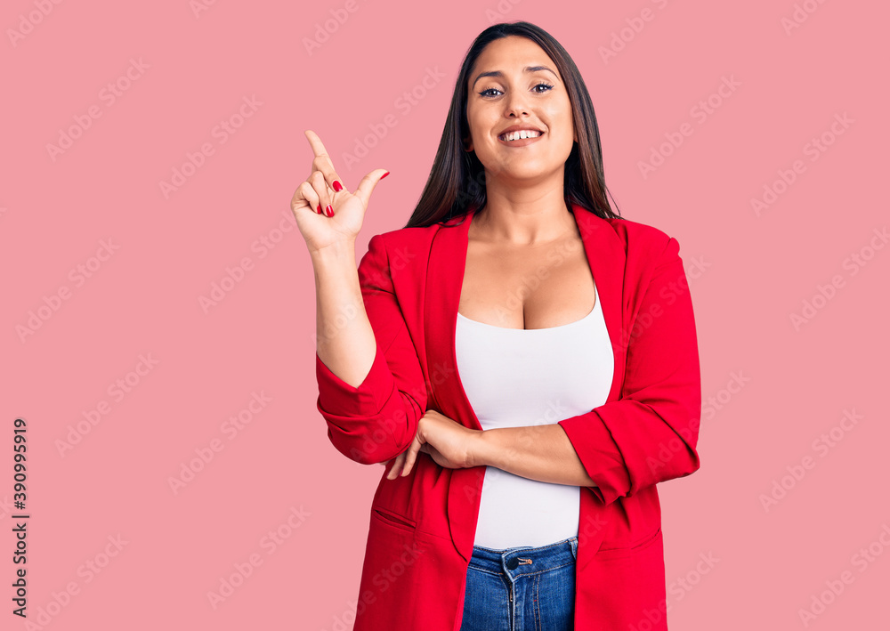Young beautiful brunette woman wearing elegant clothes with a big smile on face, pointing with hand and finger to the side looking at the camera. Young beautiful brunette woman wearing elegant clothes with a big smile on face, pointing with hand and finger to the side looking at the camera.