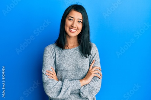 Beautiful asian young woman wearing casual clothes happy face smiling with crossed arms looking at the camera. positive person.