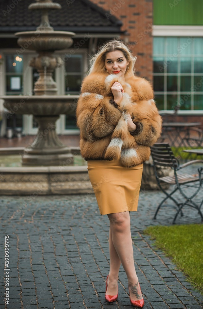 Gorgeous plus size blonde European woman in luxury fur coat, women's beauty. Concept of furs Gorgeous plus size blonde European woman in luxury fur coat, women's beauty. Concept of furs
