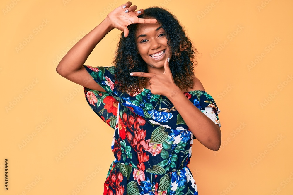 Young african american woman wearing casual clothes smiling making frame with hands and fingers with happy face. creativity and photography concept. Young african american woman wearing casual clothes smiling making frame with hands and fingers with happy face. creativity and photography concept.