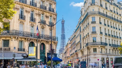 Romantic cozy view of the famous Eiffel tower from a small paris street on a cloudy autumn day with yellow gloden leaves - wide horizontal panorama.Camera zooms out