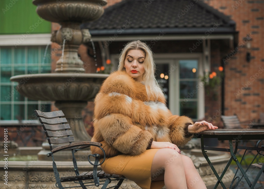 Gorgeous plus size blonde European woman in luxury fur coat, women's beauty. Concept of furs