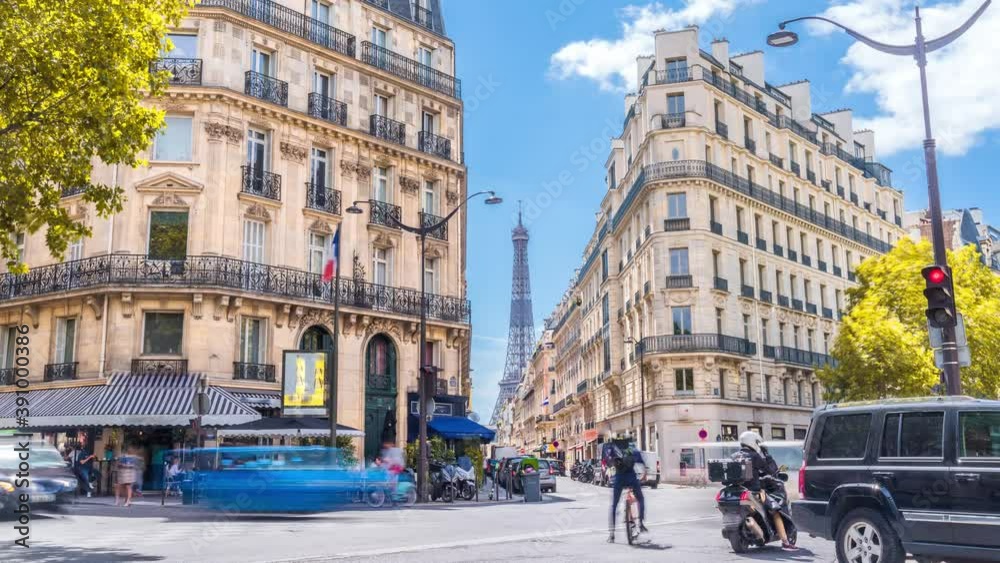 Romantic cozy view of the famous Eiffel tower from a small paris street on a cloudy autumn day with yellow gloden leaves - wide horizontal panorama.Camera zooms out