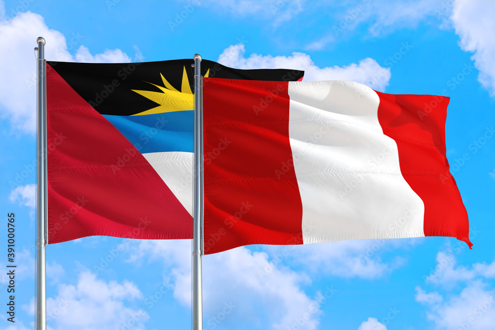 Peru and Antigua and Barbuda national flag waving in the windy deep blue sky. Diplomacy and international relations concept. Peru and Antigua and Barbuda national flag waving in the windy deep blue sky. Diplomacy and international relations concept.