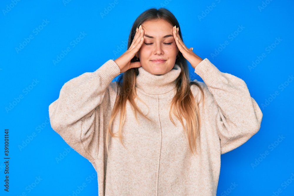 Beautiful caucasian woman wearing wool winter sweater with hand on head for pain in head because stress. suffering migraine. Beautiful caucasian woman wearing wool winter sweater with hand on head for pain in head because stress. suffering migraine.